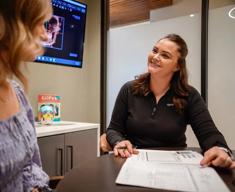 Team member going over paperwork with a patient